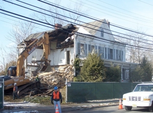 A work crew begins the demolition of the Forney House last Friday